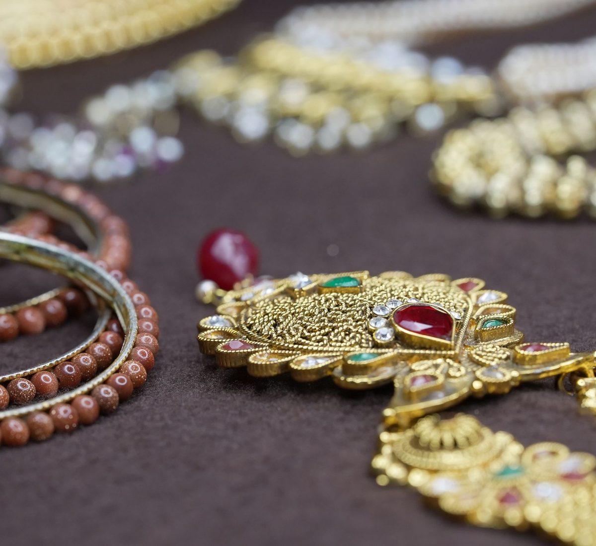 Traditional gold ornaments and bangles arranged for valuation