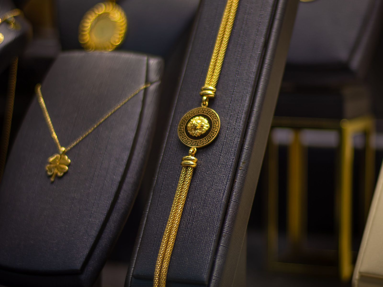 Gold chains and pendants arranged on display stands